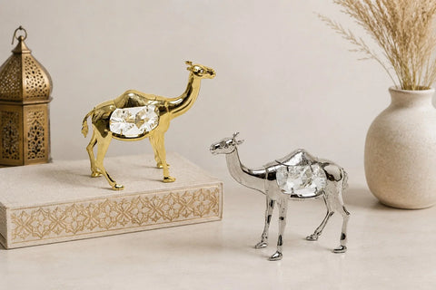 Gold and silver metallic camel figurines displayed on a table as Mini Decor Items.