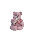 A mini 3D vintage bear with a bottle, in a beige and gray color palette, holding a small white bottle.