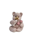 A mini 3D vintage bear with a bottle, in a beige and gray color palette, holding a small white bottle.