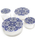 Set of glass containers with blue and white patterned lids on a white background