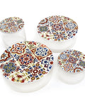 Set of four ceramic containers with colorful geometric patterns on a white background