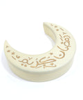 Golden porcelain canister with a gold hand-painted moon and stars design, with the phrase 'Ramadan Kareem'.