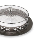 Decorative metal tray with a clear glass lid on a white background
