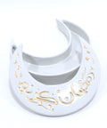 A white porcelain moon-shaped box with gold accents and the text 'Ramadan Kareem' hand painted on it.