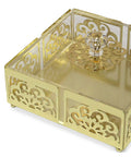 Gold decorative box with intricate patterns on a white background