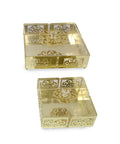 Two gold decorative boxes with intricate patterns on a white background
