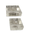 Two silver decorative boxes with intricate patterns on a white background