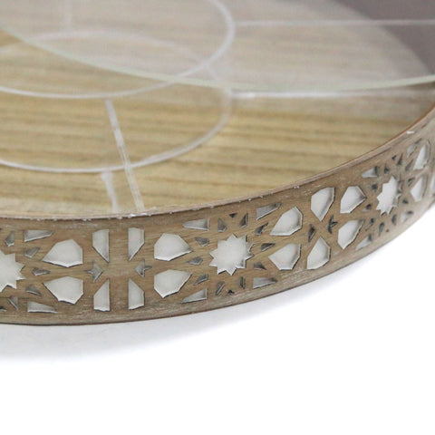 Decorative round tray with intricate cut-out design on a white background