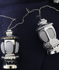 A set of silver lantern string lights with six lanterns, displayed against a dark background.
