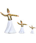 A set of three Whirling Dervish figurines in varying sizes, all wearing gold and white attire and striking a dynamic pose with arms outstretched.
