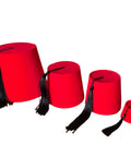 Red fez hats with black tassels on a white background