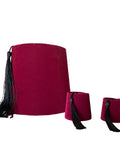 Set of three red fez hats with black tassels on a white background