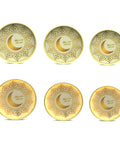 Set of six decorative plates with gold crescent moon and star design on a white background