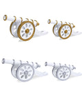 Four figurine resembling a Ramadan cannon, with whit different coloring and sizes, on a plain background.