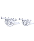 Two figurine resembling a Ramadan cannon, with white and silver coloring, on a plain background.