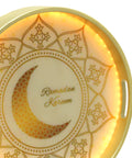 Decorative plate with 'Ramadan Kareem' text and crescent moon design and with LED on a white background