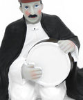 Figurine of a seated man playing the tambourine in oriental attire – rhythmic Arabic décor from the FERQA Collection.