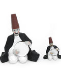 Figurine of a seated man playing the tambourine in oriental attire – rhythmic Arabic décor from the FERQA Collection.