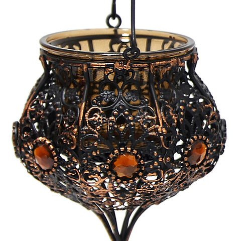 Vintage hanging candle holder adorned with beads and stones – ornate lantern décor for warm, festive ambiance.