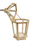 A large wooden lantern with a hexagonal shape and a metal handle, featuring clear glass panels and a dome top with white background.