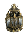 Decorative brass lantern with intricate designs on a white background