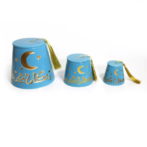 Fez-shaped porcelain canister with gold tassel and Ramadan Kareem calligraphy – elegant Ramadan décor accent.